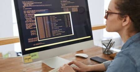 woman standing in front of a computer